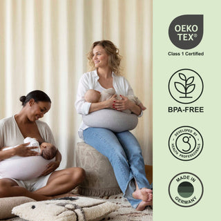 Woman holding a baby with Oeko-Tex and BPA-Free certification logos on the right bbhugme nursing pillow